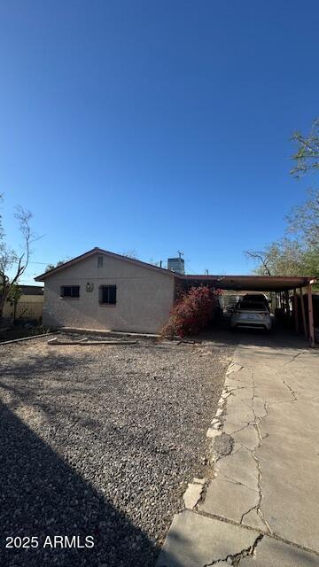 3530 W Portland St, Phoenix, AZ 85009 - view of home's exterior with driveway and a carport