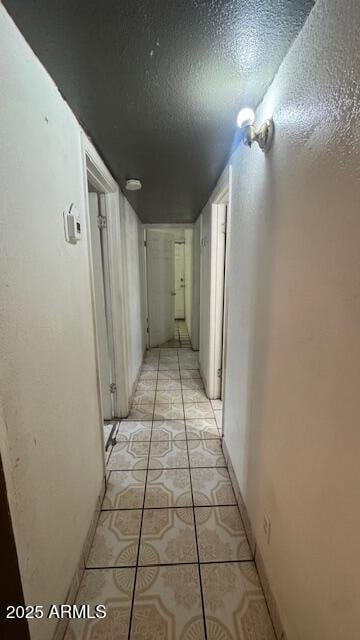 3530 W Portland St, Phoenix, AZ 85009 - hallway featuring light tile patterned flooring, a textured ceiling, and baseboards