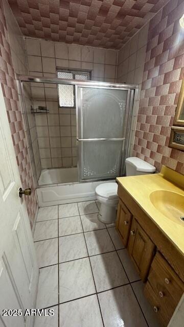 3530 W Portland St, Phoenix, AZ 85009 - bathroom featuring vanity, toilet, enclosed tub / shower combo, and tile patterned flooring