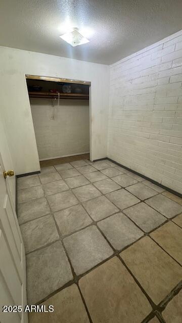 3530 W Portland St, Phoenix, AZ 85009 - unfurnished bedroom with a textured ceiling and a closet