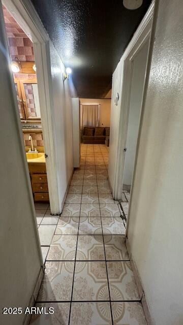 3530 W Portland St, Phoenix, AZ 85009 - hallway with a sink and light tile patterned flooring