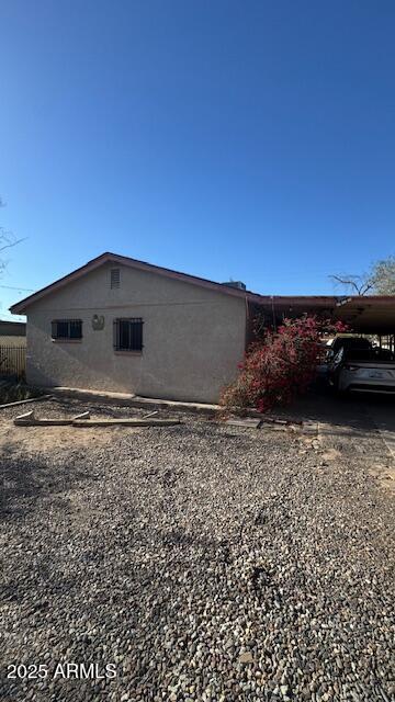 3530 W Portland St, Phoenix, AZ 85009 - view of side of property with driveway and a carport