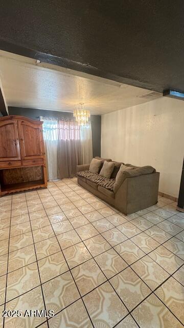 3530 W Portland St, Phoenix, AZ 85009 - living room with light tile patterned floors and a chandelier