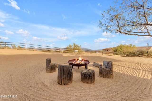 view of yard featuring an outdoor fire pit