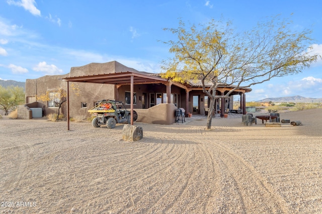 back of property featuring a mountain view