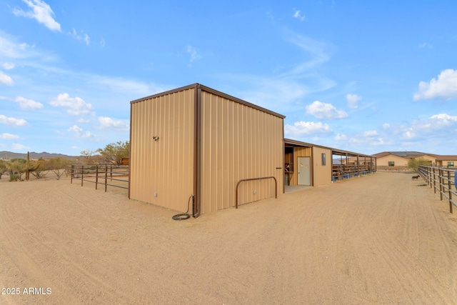 view of outdoor structure with a rural view