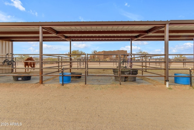 view of horse barn featuring a rural view