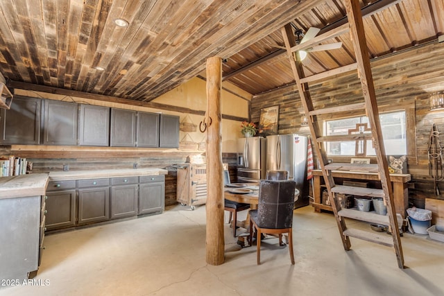 interior space with dark brown cabinets, stainless steel fridge, high vaulted ceiling, and stainless steel refrigerator