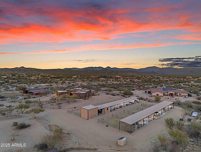 aerial view at dusk featuring a mountain view