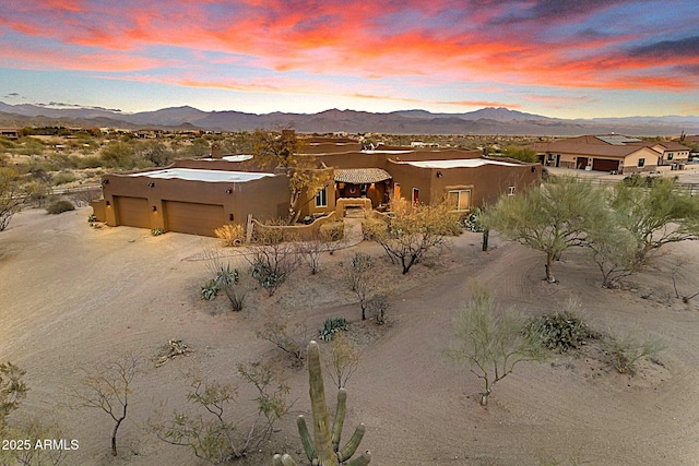 view of front facade featuring a garage and a mountain view