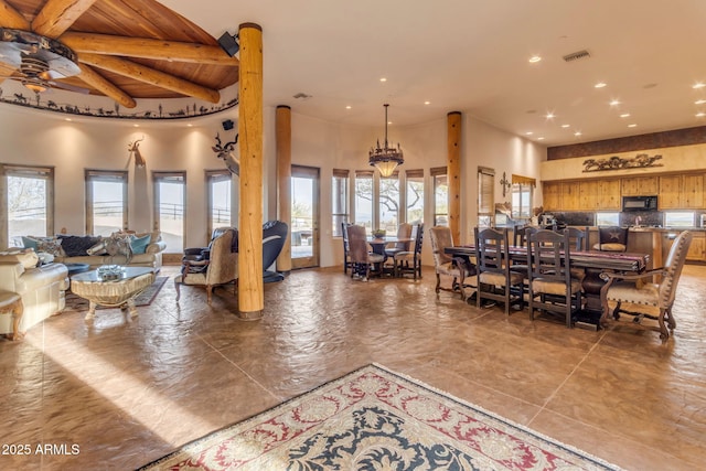 dining room with ceiling fan, a wealth of natural light, wooden ceiling, and beamed ceiling