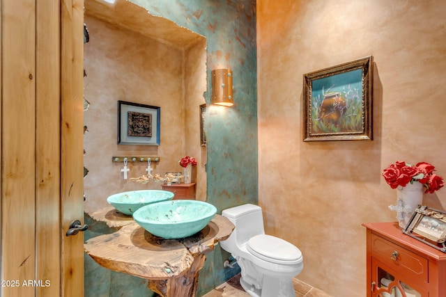 bathroom featuring tile patterned floors and toilet