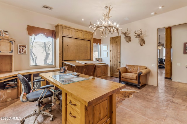 home office with a chandelier and light tile patterned floors