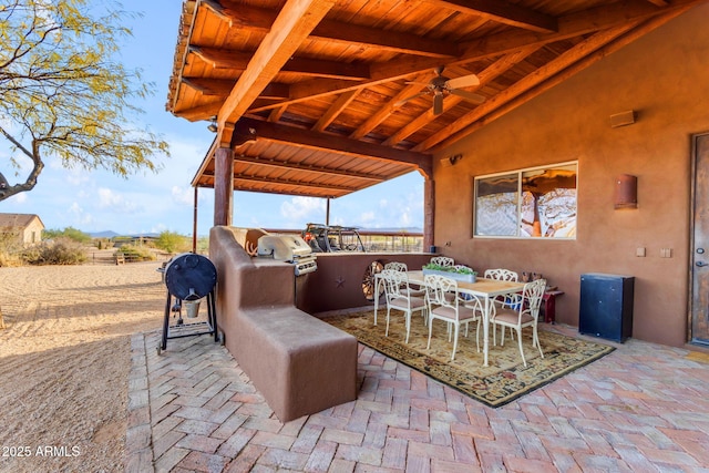 view of patio / terrace with ceiling fan and area for grilling