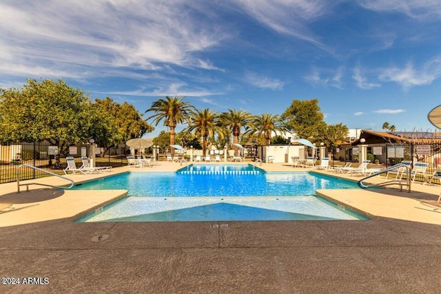 pool featuring a patio area and fence