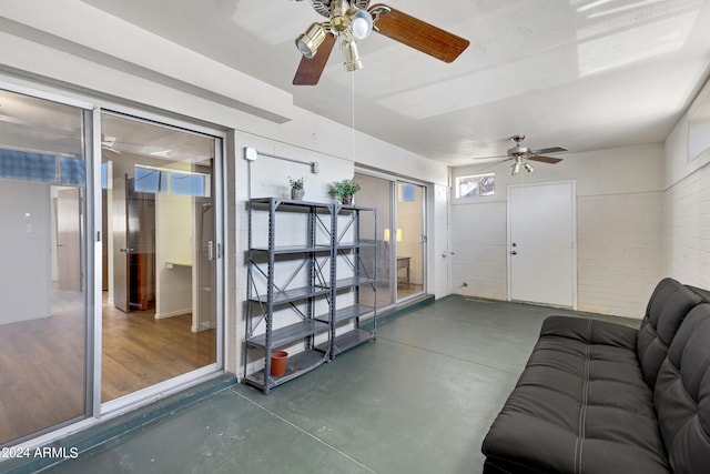 interior space featuring concrete flooring and a ceiling fan