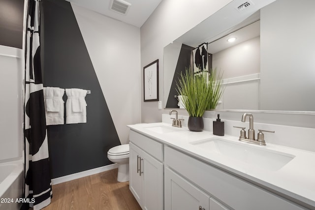 bathroom with visible vents, wood finished floors, and a sink