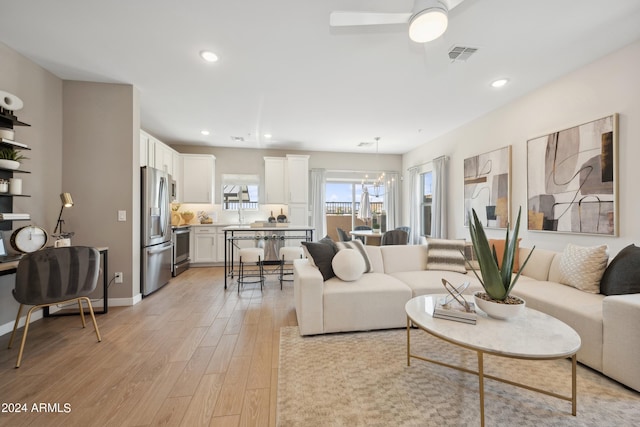 living area featuring visible vents, recessed lighting, light wood finished floors, baseboards, and ceiling fan