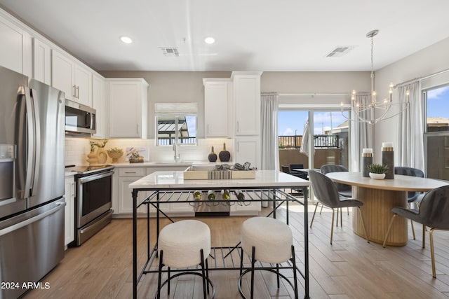 kitchen with visible vents, stainless steel appliances, light countertops, and a sink