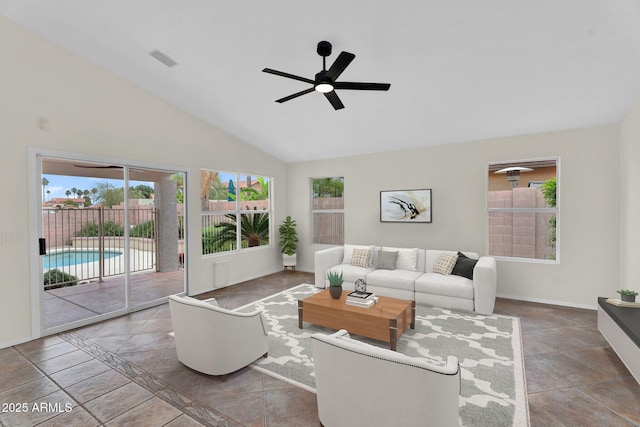 living area with plenty of natural light, a ceiling fan, baseboards, and high vaulted ceiling