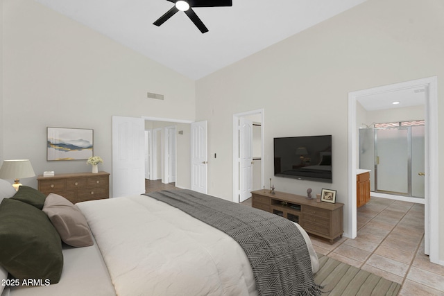 bedroom with high vaulted ceiling, a ceiling fan, and ensuite bath