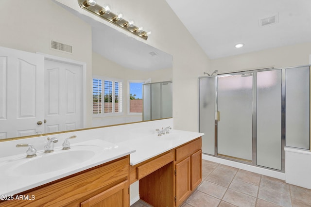 full bathroom with a stall shower, double vanity, tile patterned floors, and vaulted ceiling