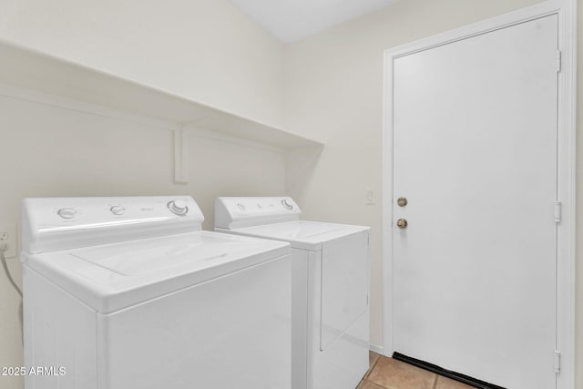 laundry area featuring washer and clothes dryer and light tile patterned floors