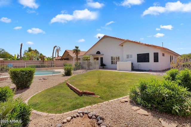 back of property featuring stucco siding and a tiled roof