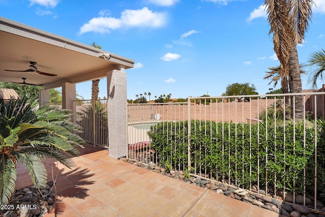 view of patio with ceiling fan and fence
