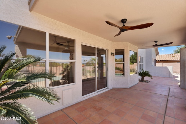 view of patio featuring ceiling fan and fence