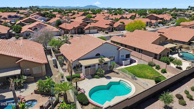aerial perspective of suburban area featuring a pool
