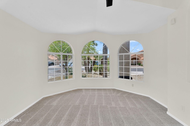 carpeted empty room with baseboards