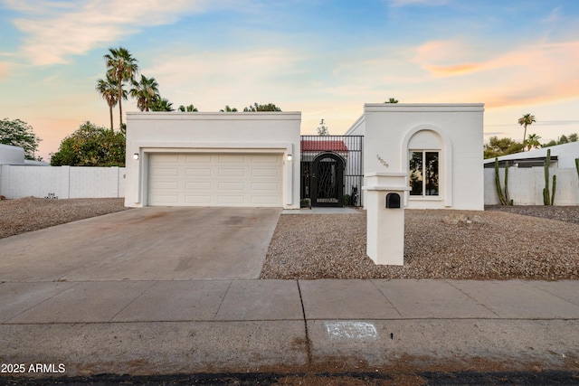 14029 N Burning Tree Pl, Phoenix, AZ 85022 - mediterranean / spanish-style house featuring concrete driveway, a garage, stucco siding, and a gate