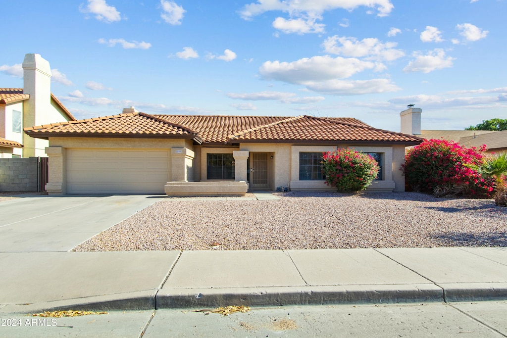 mediterranean / spanish-style home with a garage