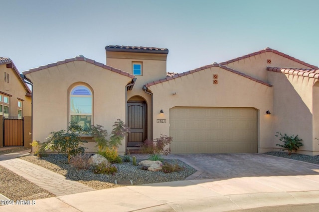 mediterranean / spanish house featuring a garage