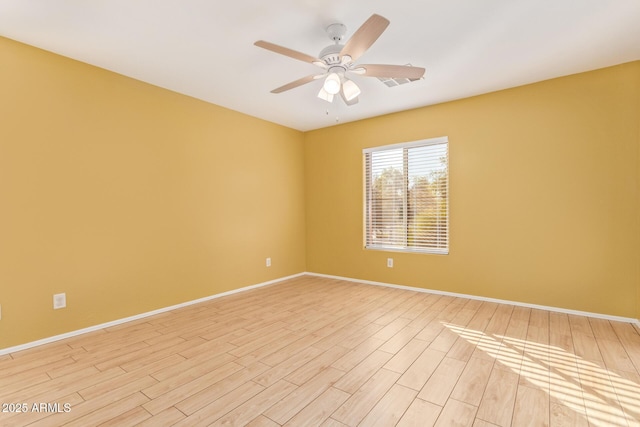 empty room featuring light wood-type flooring and ceiling fan