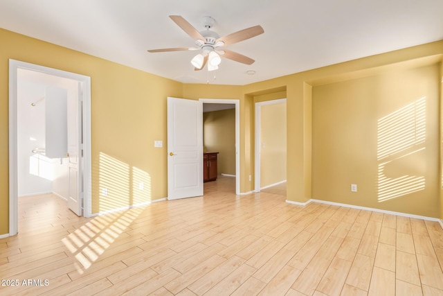 empty room with light wood-type flooring and ceiling fan