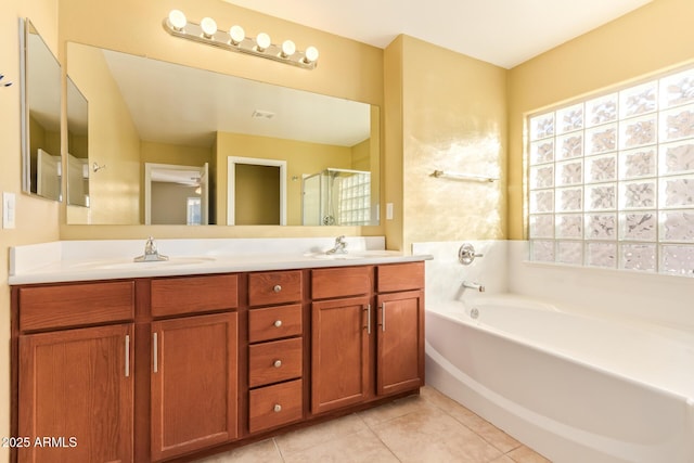 bathroom with independent shower and bath, vanity, and tile patterned floors