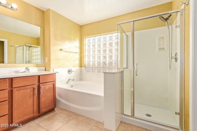 bathroom featuring tile patterned flooring, plus walk in shower, and vanity