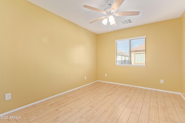 spare room featuring ceiling fan and light hardwood / wood-style flooring