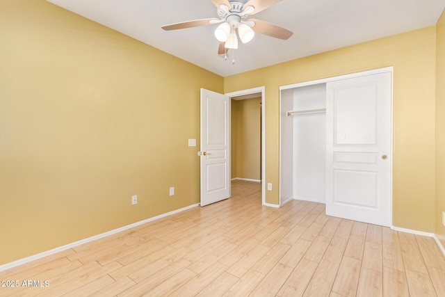 unfurnished bedroom featuring ceiling fan, a closet, and light hardwood / wood-style floors