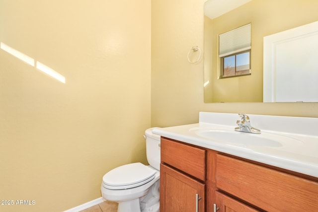 bathroom with tile patterned flooring, vanity, and toilet