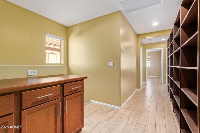 corridor featuring light hardwood / wood-style floors and plenty of natural light