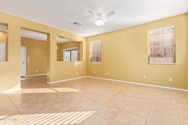 empty room with light tile patterned flooring and ceiling fan