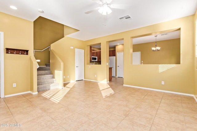 interior space with ceiling fan with notable chandelier