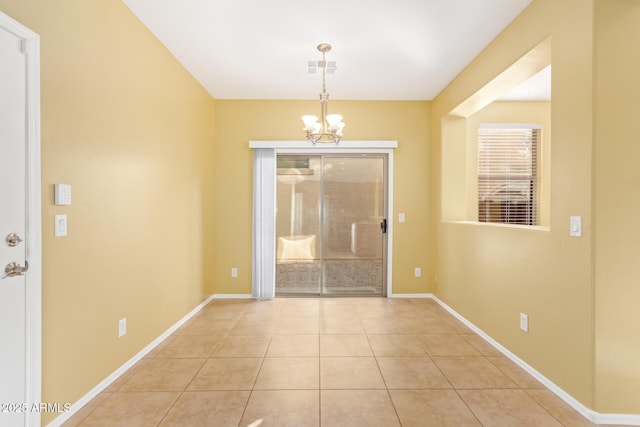 entrance foyer with an inviting chandelier and light tile patterned floors