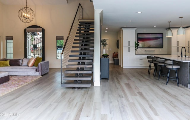 10266 E Caron St, Scottsdale, AZ 85258 - living area with stairs, light wood-type flooring, recessed lighting, and arched walkways