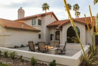10266 E Caron St, Scottsdale, AZ 85258 - rear view of property with a fire pit, a tiled roof, stucco siding, and a chimney