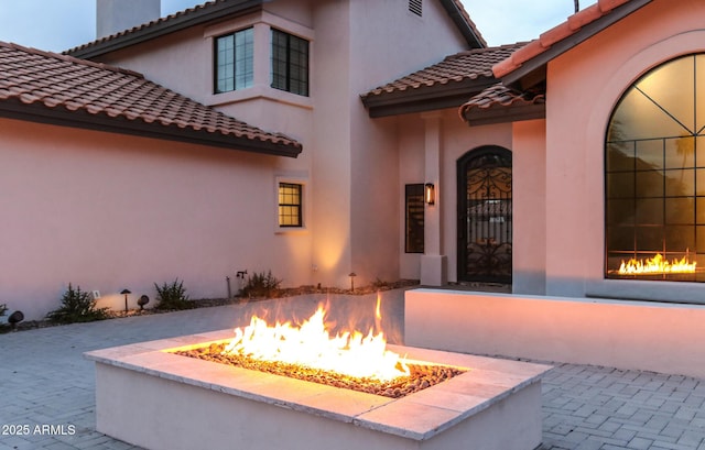 10266 E Caron St, Scottsdale, AZ 85258 - view of exterior entry with a tile roof, stucco siding, and a patio