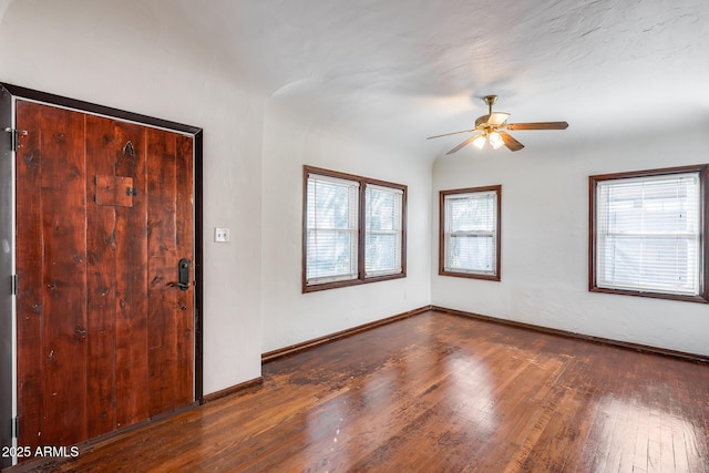 entryway featuring dark wood-type flooring and ceiling fan